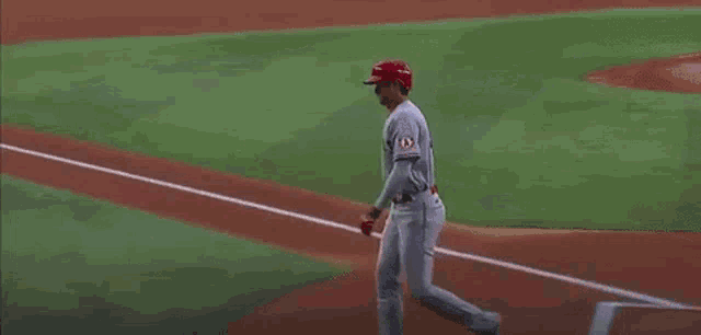 a baseball player wearing a jersey with the number 42 on it is running on the field .