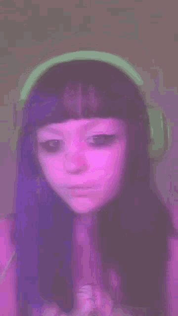 a close up of a person 's face with a pink background .
