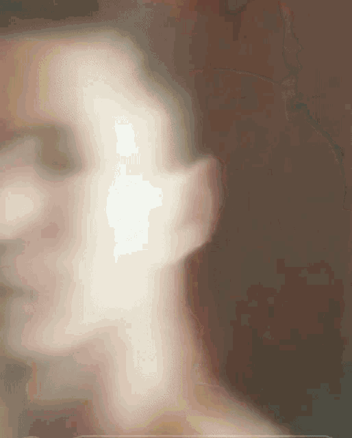 a blurry picture of a man 's face with a blurred background .