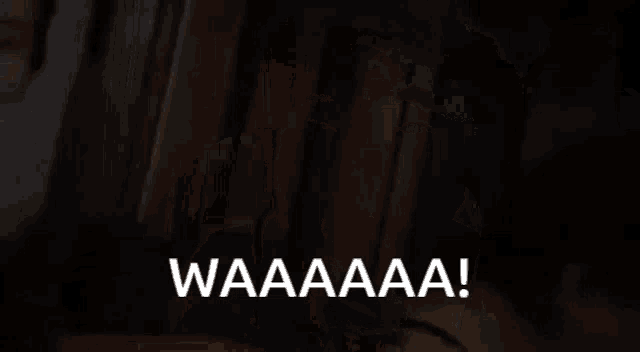 a woman is screaming into a microphone and the words waaaa are visible in the corner