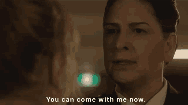 a woman says " you can come with me now "
