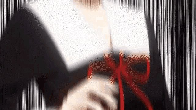a blurry picture of a woman in a black and white dress with a red bow .