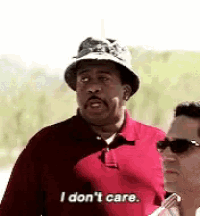 a man wearing a hat and sunglasses is standing next to another man and saying `` i don 't care '' .