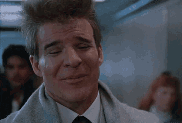 a man in a grey coat says mama on his face