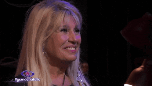 a close up of a woman 's face with the words grandefratello on the bottom