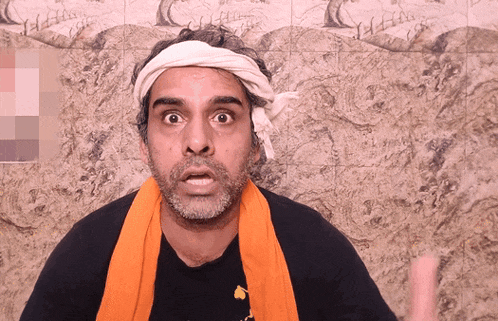 a man with a bandana on his head and an orange towel around his neck