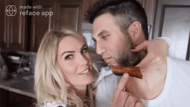 a man is biting into a piece of bacon while a woman watches
