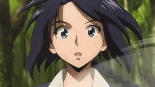 a close up of a girl 's face with a surprised expression