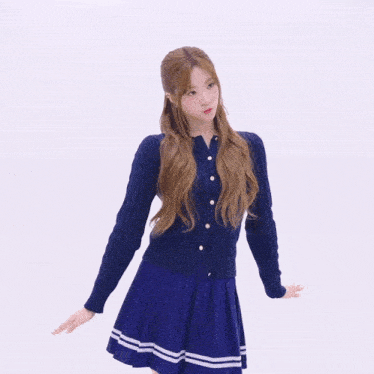 a woman wearing a blue sweater and a blue skirt