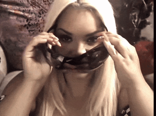 a blonde woman wearing a mask with a leopard print on it