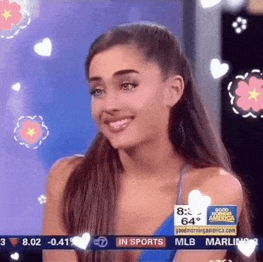a woman is smiling in front of a screen that says " good morning america "
