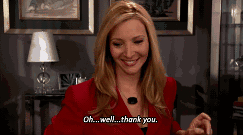 a woman in a red jacket is smiling and says oh well thank you