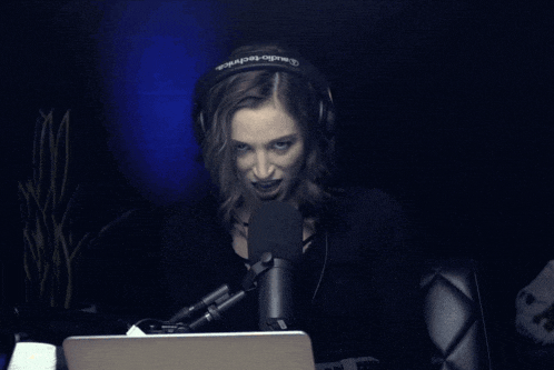 a woman wearing headphones with the word audio-technica on them