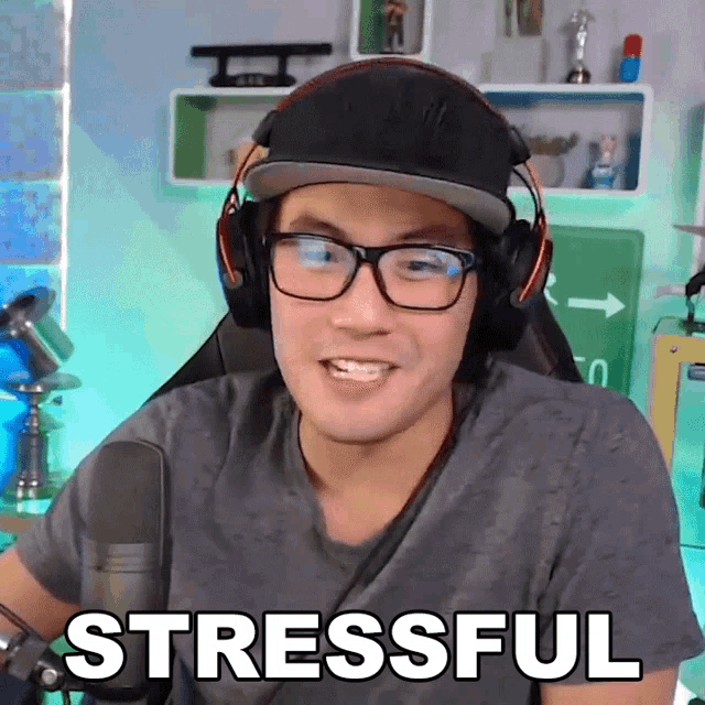 a man wearing headphones and glasses says " stressful "