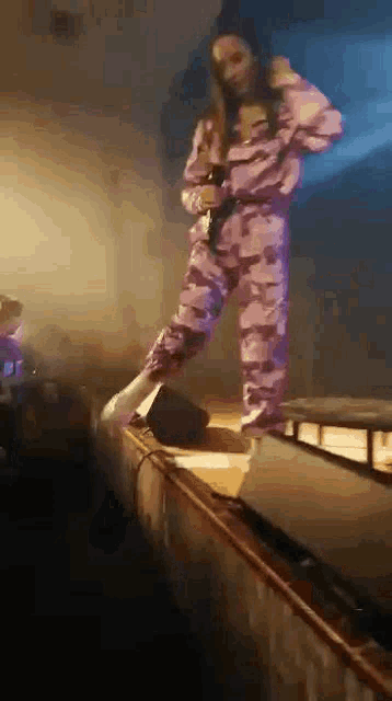 a woman is standing on a stage with a microphone in her hand .