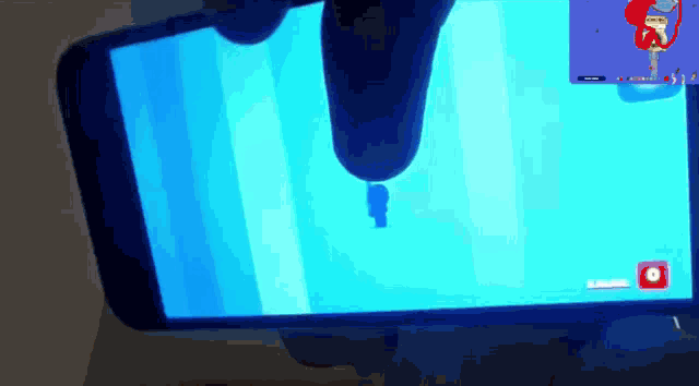 a person is playing a video game on a phone