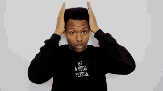 a man wearing a black shirt that says " be a good person "