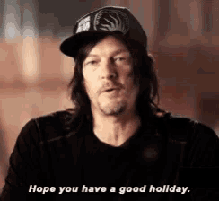 a man wearing a baseball cap is saying `` hope you have a good holiday '' .
