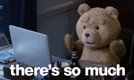 a teddy bear is sitting at a desk in front of a laptop with the words there 's so much above him