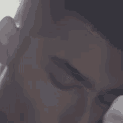 a close up of a person 's face with glasses covering their face .
