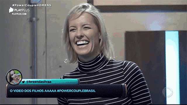 a woman is laughing in front of a screen that says #powercouplehomens