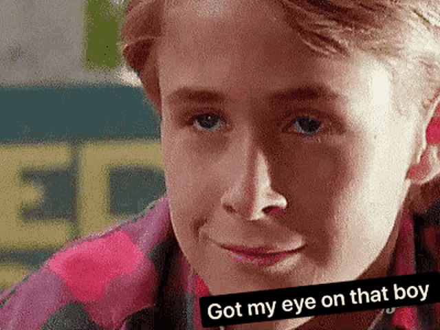a close up of a young boy 's face with the words `` got my eye on that boy '' written above him .