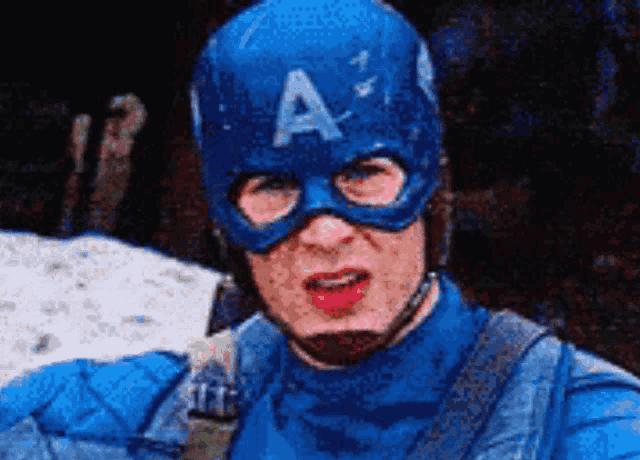 a man in a captain america costume is wearing a mask and helmet