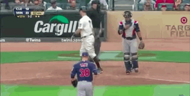 a baseball game is being played in front of a sign for cargill