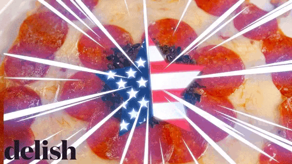 a pepperoni pizza with an american flag in the middle and the word delish below it