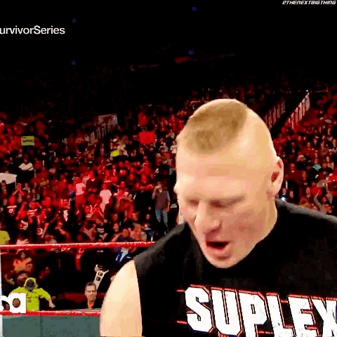 a man is wearing a black shirt that says suplex on it