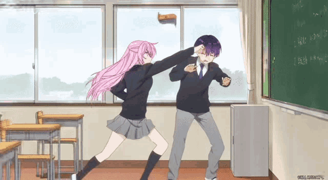 a boy and a girl are dancing in a classroom with a blackboard that says ' a ' on it