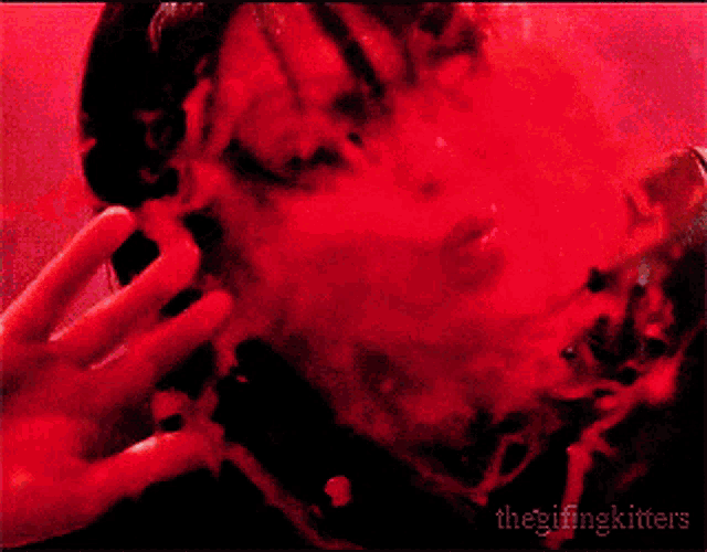 a person with red smoke coming out of their mouth and the words thegifingkitters below