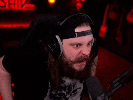 a man with long hair and a beard wearing headphones and a hat that says snl