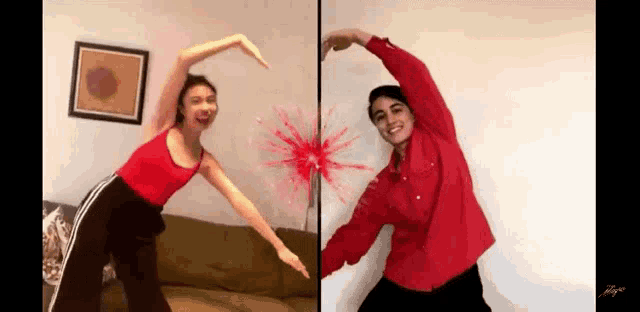 a man and a woman are making a heart shape with their hands in front of a couch .