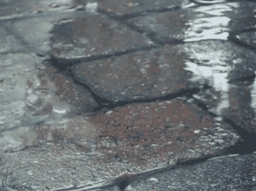 a puddle of water on a brick floor