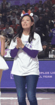a woman wearing a white shirt that says ' plus league ' on the front