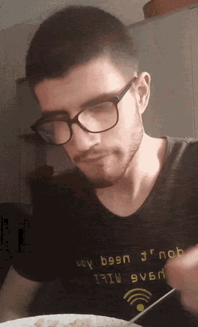 a man wearing glasses and a t-shirt that says very been jr nob