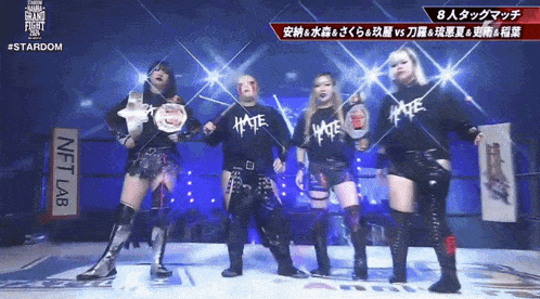 a group of women are standing in front of a sign that says " nft lab "