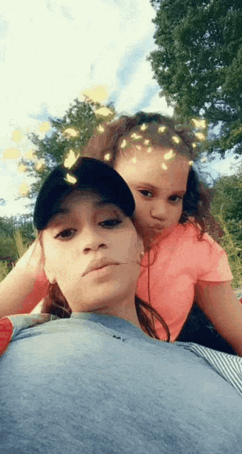 a woman and a little girl are posing for a photo