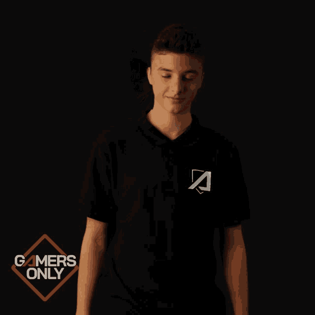 a man wearing a black shirt with the letter a on it