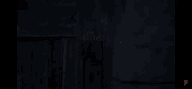 a dark room with a lightning bolt on the bottom right