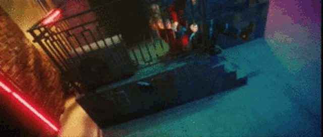 a person is flying through the air in a dark room with a red light behind them .