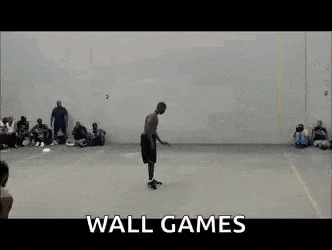two men are playing wall games on a court .