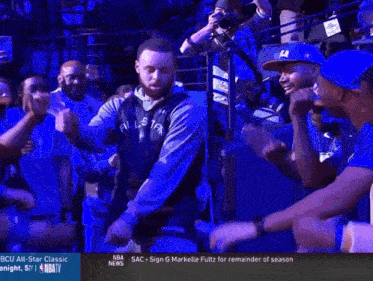 a basketball player is dancing in front of a crowd with the nba news on the bottom right