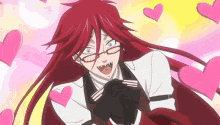 a man with long red hair and glasses is surrounded by pink hearts and making a funny face .