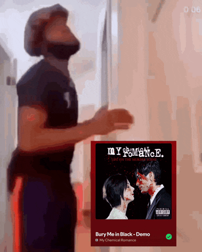 a man is standing in front of a poster for my chemical romance 's bury me in black