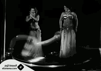 a black and white photo of two belly dancers with elcinema.com written on the bottom