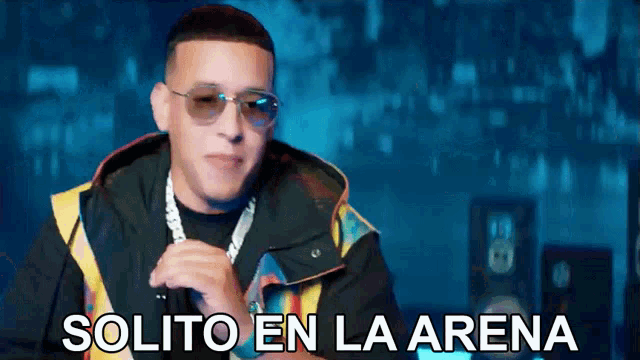 a man wearing sunglasses and a jacket with the words solito en la arena above him