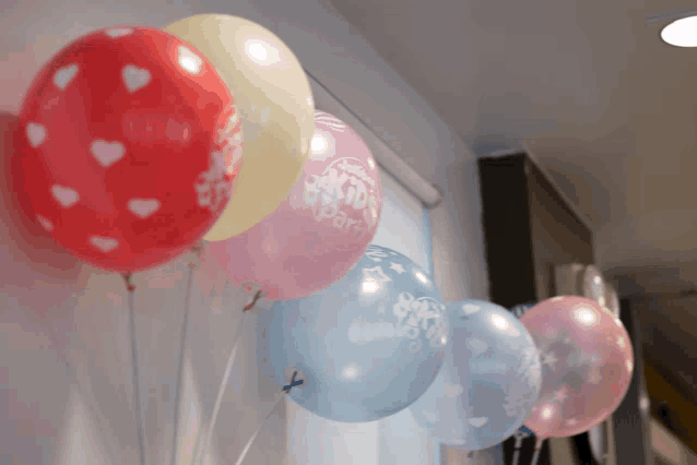 a row of balloons including one that says ' kids party '