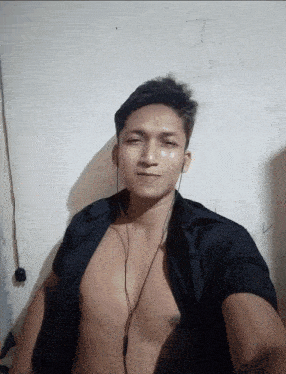 a shirtless man is wearing headphones and a black shirt